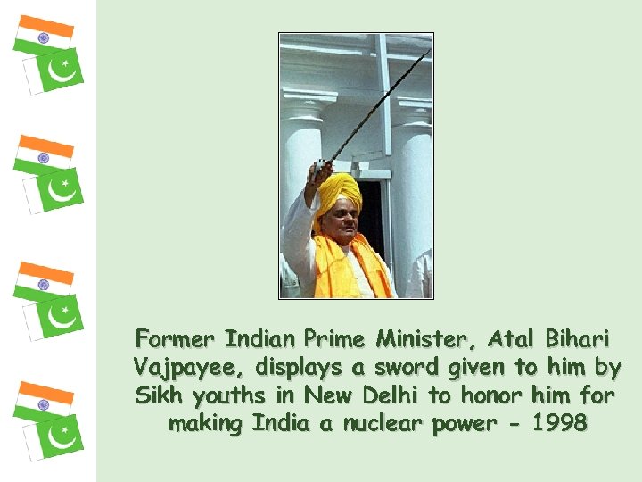 Former Indian Prime Minister, Atal Bihari Vajpayee, displays a sword given to him by