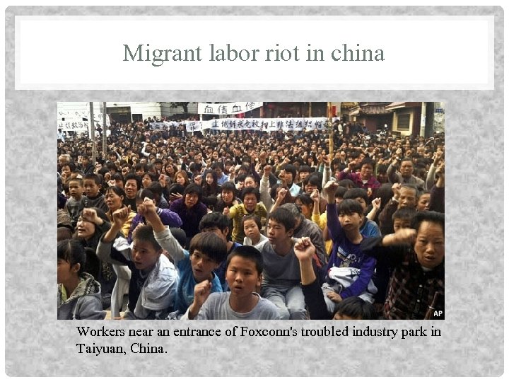 Migrant labor riot in china Workers near an entrance of Foxconn's troubled industry park