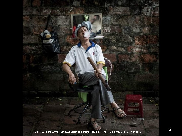 VIETNAM, Hanoi, 20 faces in 2013: Street barber smoking a pipe. (Photo: Chris Mc.