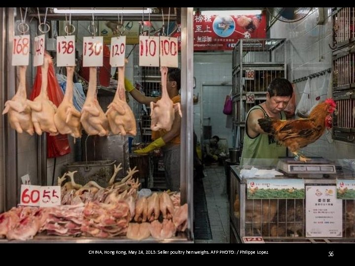 CHINA, Hong Kong, May 24, 2013: Seller poultry hen weighs. AFP PHOTO: / Philippe