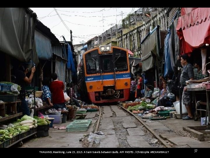 THAILAND, Maeklong, June 25, 2013: A train travels between stalls. AFP PHOTO: / Christophe