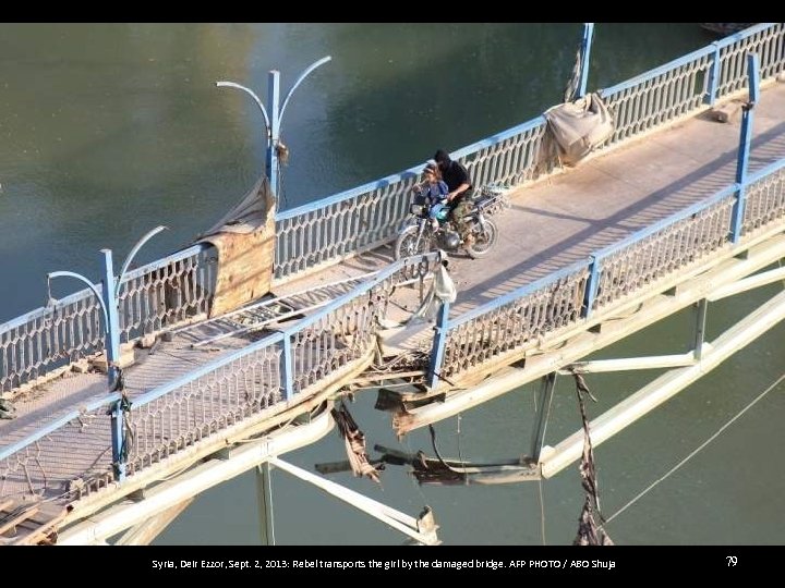 Syria, Deir Ezzor, Sept. 2, 2013: Rebel transports the girl by the damaged bridge.