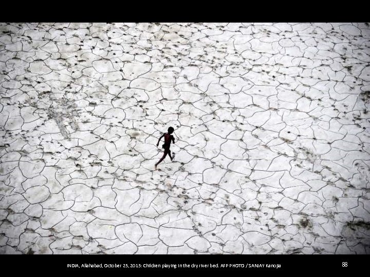 INDIA, Allahabad, October 25, 2013: Children playing in the dry river bed. AFP PHOTO