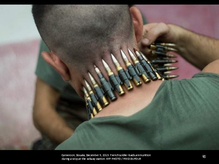Cameroon, Douala, December 3, 2013: French soldier loads ammunition during a stop at the