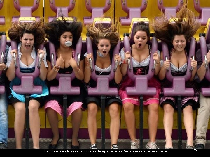 GERMANY, Munich, October 6, 2013: Girls playing during Oktoberfest. AFP PHOTO / CHRISTOF STACHE