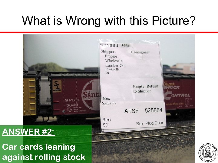 What is Wrong with this Picture? ANSWER #2: Car cards leaning against rolling stock