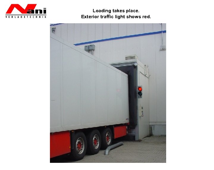 Loading takes place. Exterior traffic light shows red. 