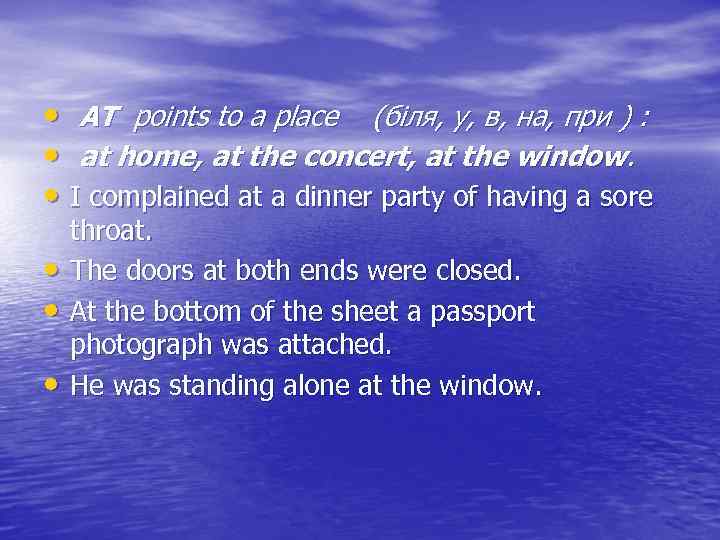  • AT points to a place (біля, у, в, на, при ) :