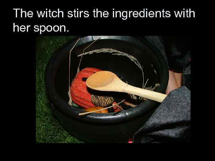 The witch stirs the ingredients with her spoon. 