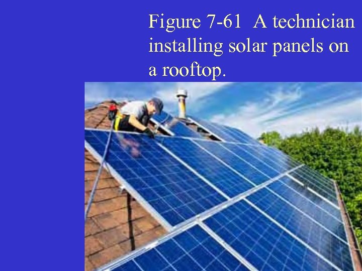 Figure 7 -61 A technician installing solar panels on a rooftop. 