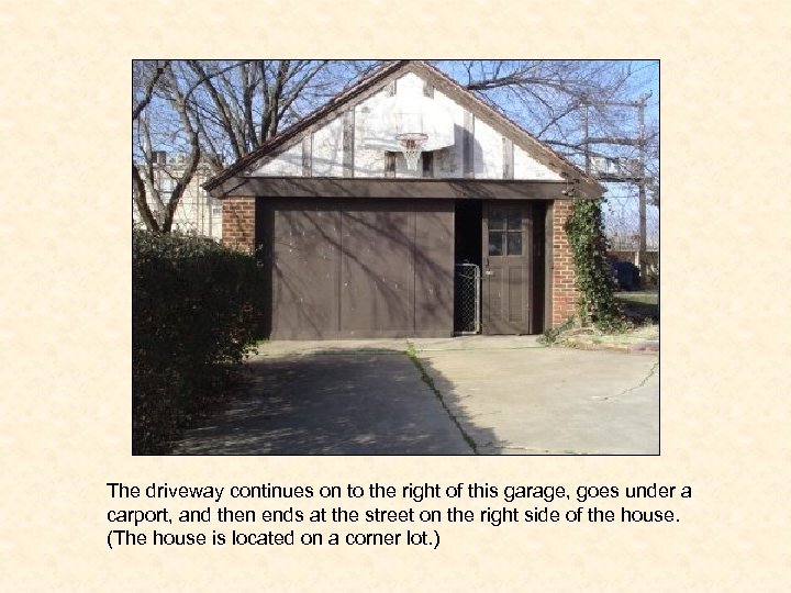 The driveway continues on to the right of this garage, goes under a carport,
