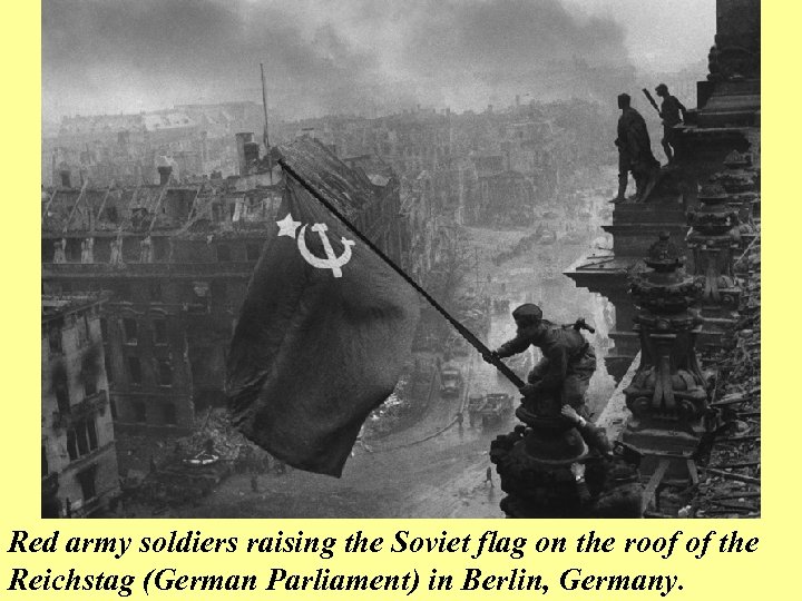 Red army soldiers raising the Soviet flag on the roof of the Reichstag (German