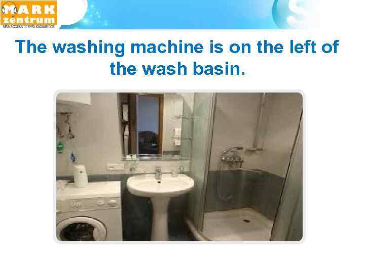  The washing machine is on the left of the wash basin. 