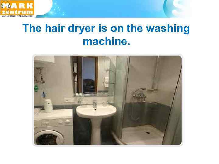  The hair dryer is on the washing machine. 