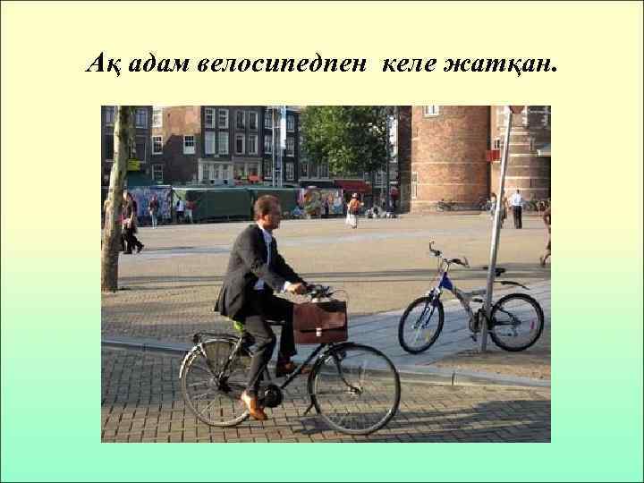 Ақ адам велосипедпен келе жатқан. 