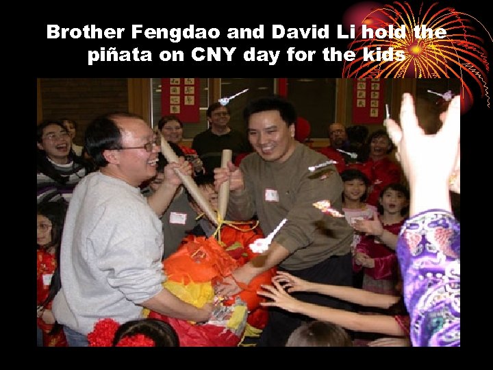 Brother Fengdao and David Li hold the piñata on CNY day for the kids