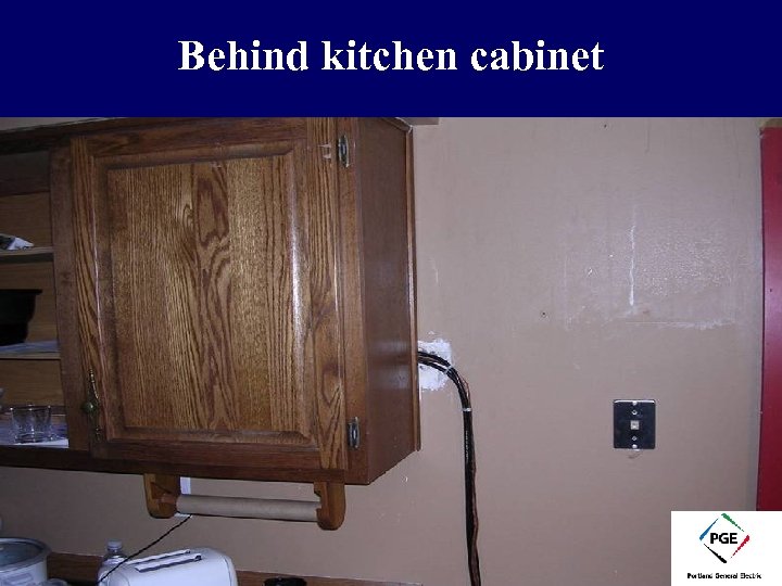 Behind kitchen cabinet 