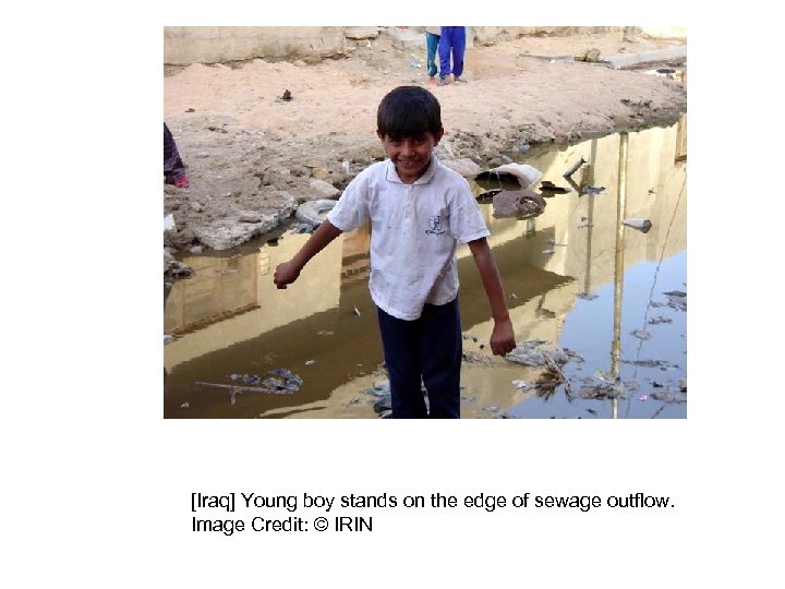 [Iraq] Young boy stands on the edge of sewage outflow. Image Credit: © IRIN