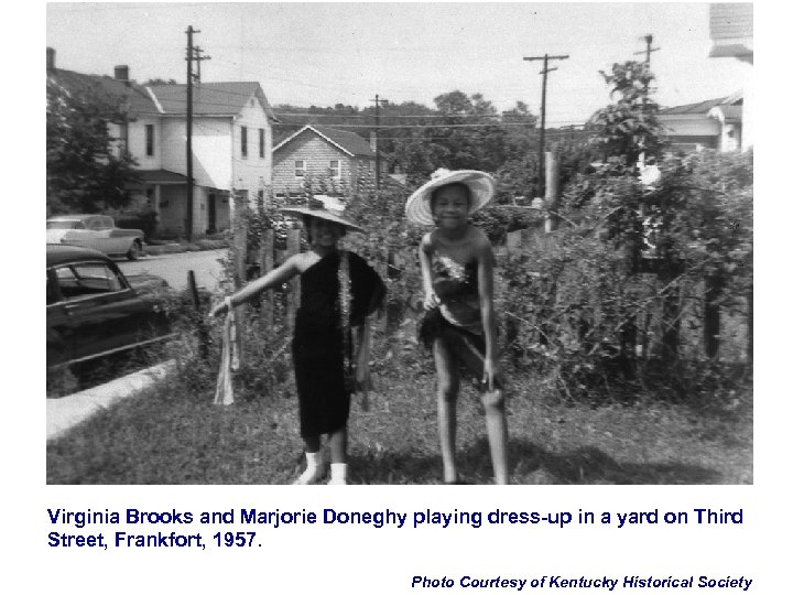 Virginia Brooks and Marjorie Doneghy playing dress-up in a yard on Third Street, Frankfort,