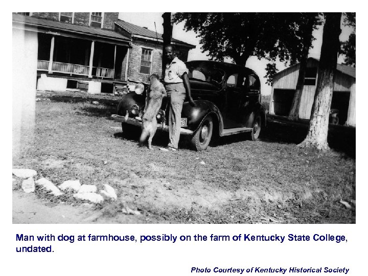 Man with dog at farmhouse, possibly on the farm of Kentucky State College, undated.