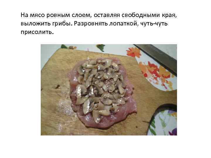 На мясо ровным слоем, оставляя свободными края, выложить грибы. Разровнять лопаткой, чуть-чуть присолить. 