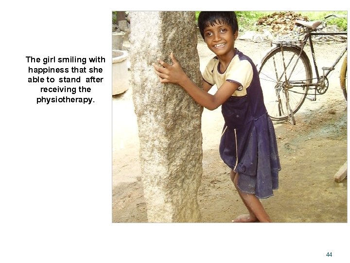 The girl smiling with happiness that she able to stand after receiving the physiotherapy.