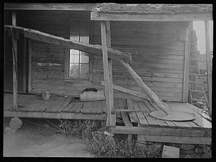 Porch of a sharecropper's cabin. Hale County, Alabama, Summer 1936. The marginal and oppressive