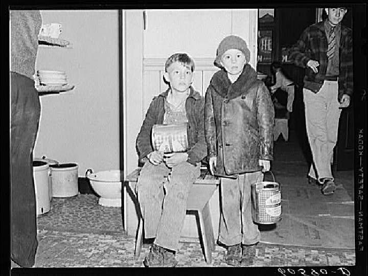 Young boys waiting in kitchen of city mission for soup which is given out
