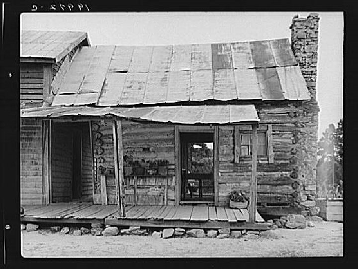 Sharecropper house on dirt. Dirt log cabin on right is much older than attached