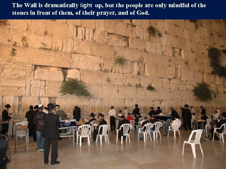 The Wall is dramatically light up, but the people are only mindful of the