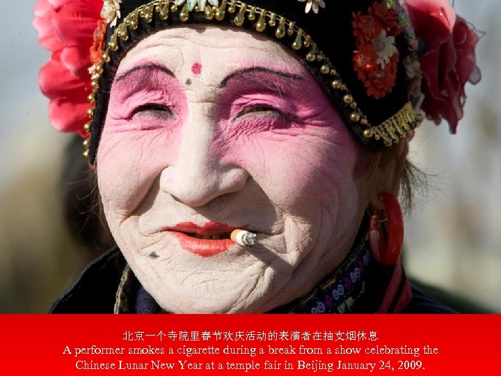 北京一个寺院里春节欢庆活动的表演者在抽支烟休息 A performer smokes a cigarette during a break from a show celebrating the