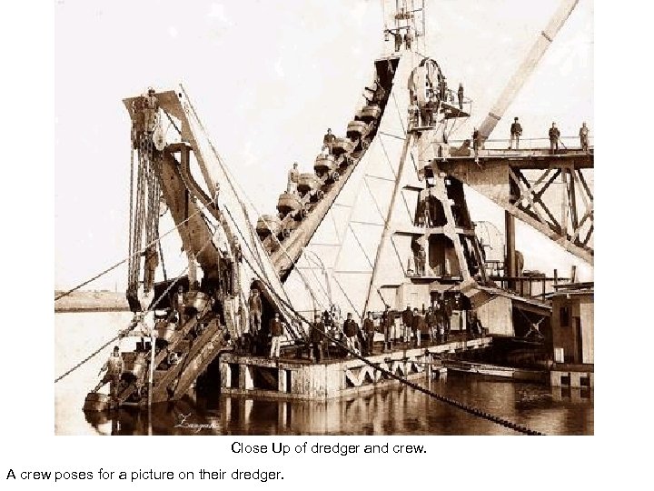 Close Up of dredger and crew. A crew poses for a picture on their