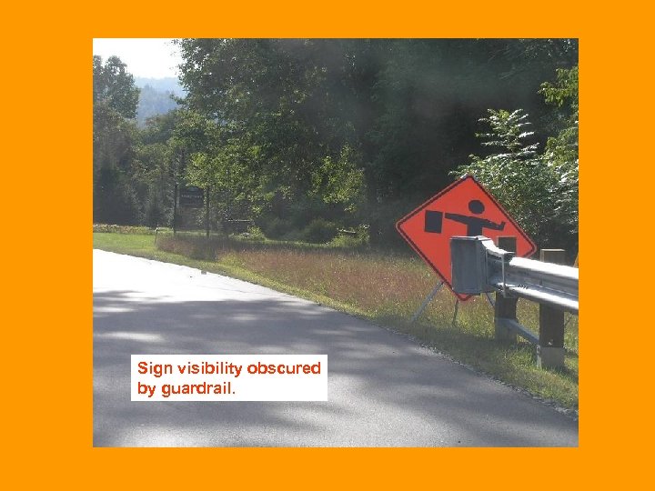 Sign visibility obscured by guardrail. 