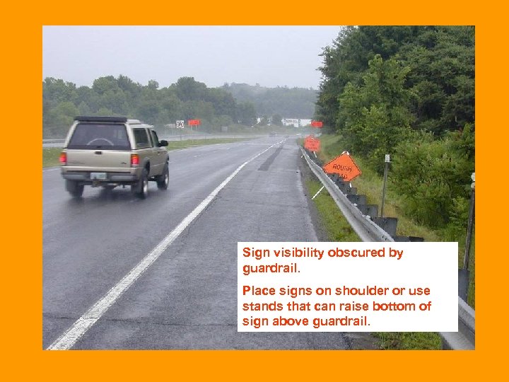 Sign visibility obscured by guardrail. Place signs on shoulder or use stands that can