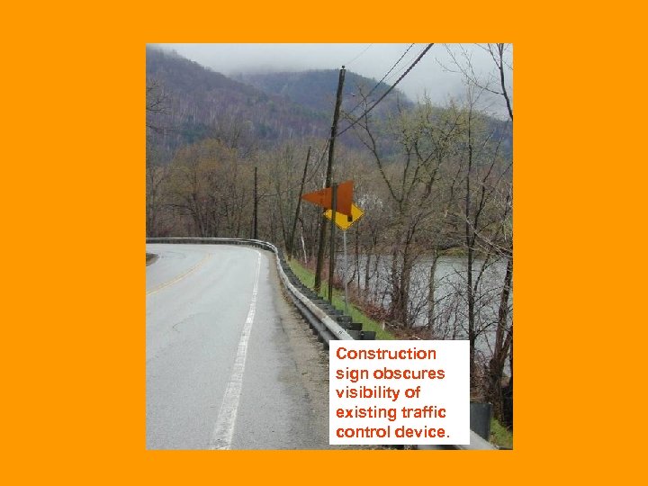 Construction sign obscures visibility of existing traffic control device. 