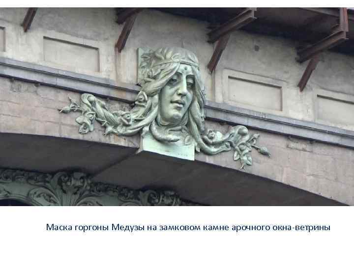 Маска горгоны Медузы на замковом камне арочного окна-ветрины 