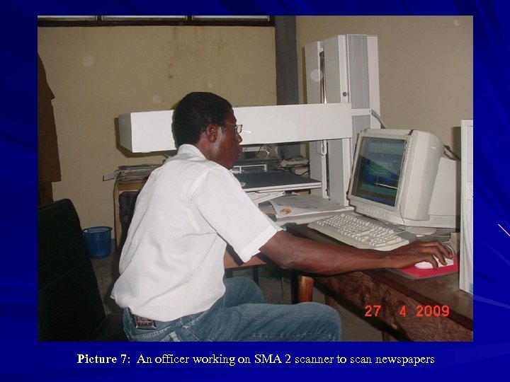 Picture 7: An officer working on SMA 2 scanner to scan newspapers 