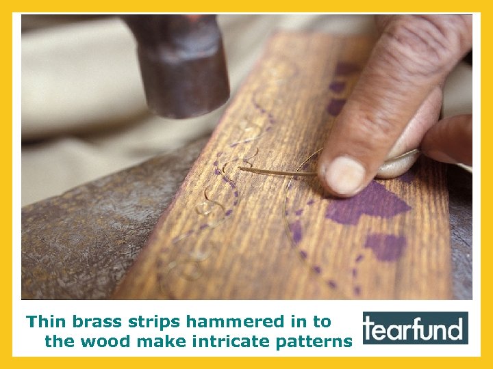 Thin brass strips hammered in to the wood make intricate patterns 