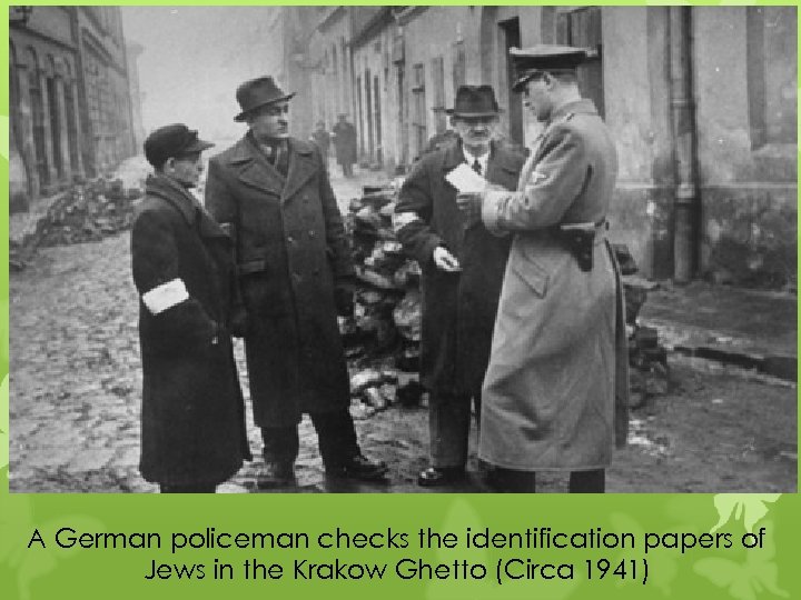 A German policeman checks the identification papers of Jews in the Krakow Ghetto (Circa