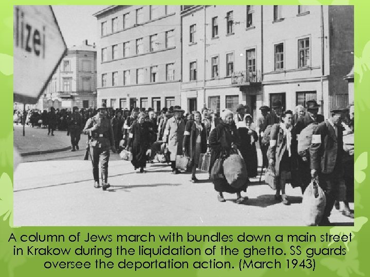 A column of Jews march with bundles down a main street in Krakow during