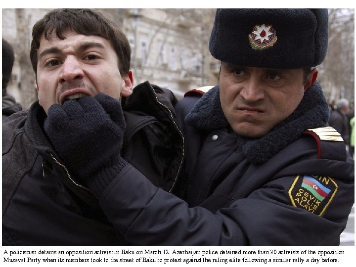 A policeman detains an opposition activist in Baku on March 12. Azerbaijan police detained