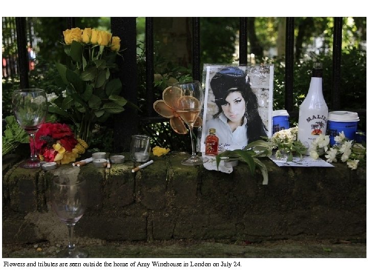 Flowers and tributes are seen outside the home of Amy Winehouse in London on