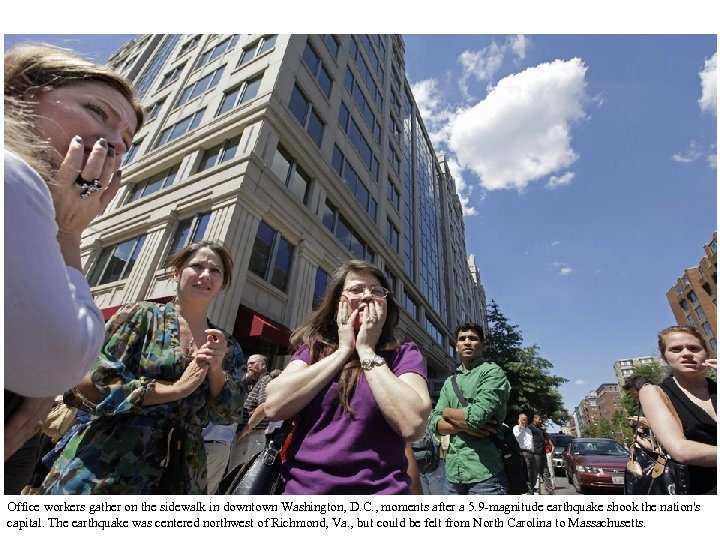 Office workers gather on the sidewalk in downtown Washington, D. C. , moments after