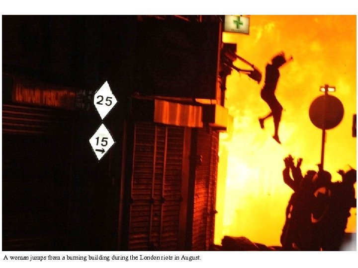A woman jumps from a burning building during the London riots in August. 