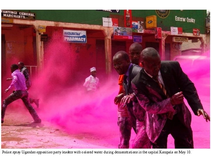 Police spray Ugandan opposition party leaders with colored water during demonstrations in the capital