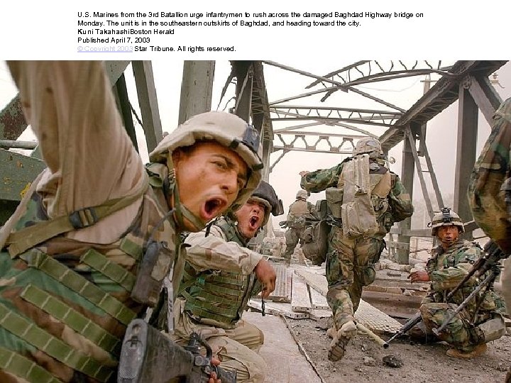 U. S. Marines from the 3 rd Batallion urge infantrymen to rush across the