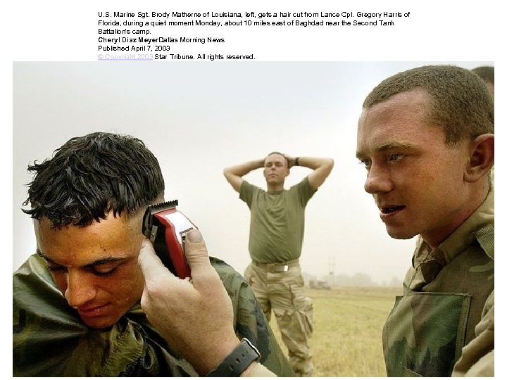U. S. Marine Sgt. Brody Matherne of Louisiana, left, gets a hair cut from