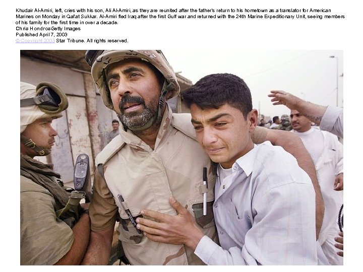 Khudair Al-Amiri, left, cries with his son, Ali Al-Amiri, as they are reunited after