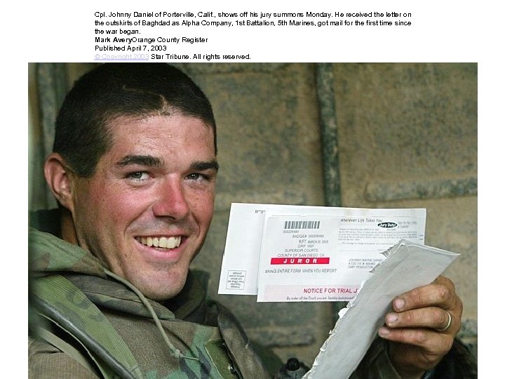 Cpl. Johnny Daniel of Porterville, Calif. , shows off his jury summons Monday. He