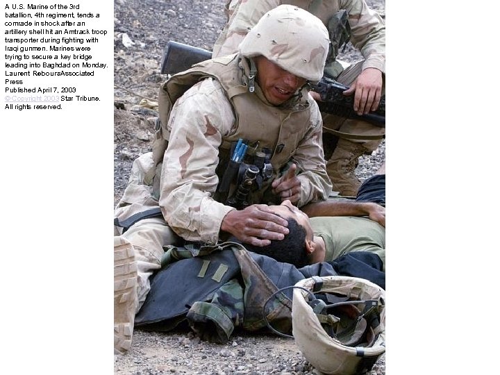 A U. S. Marine of the 3 rd batallion, 4 th regiment, tends a